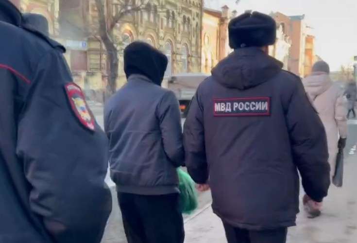 Сотрудники полиции ведут задержанного