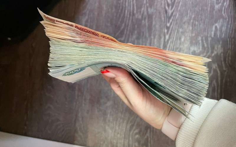Пачка денегг в женской руке