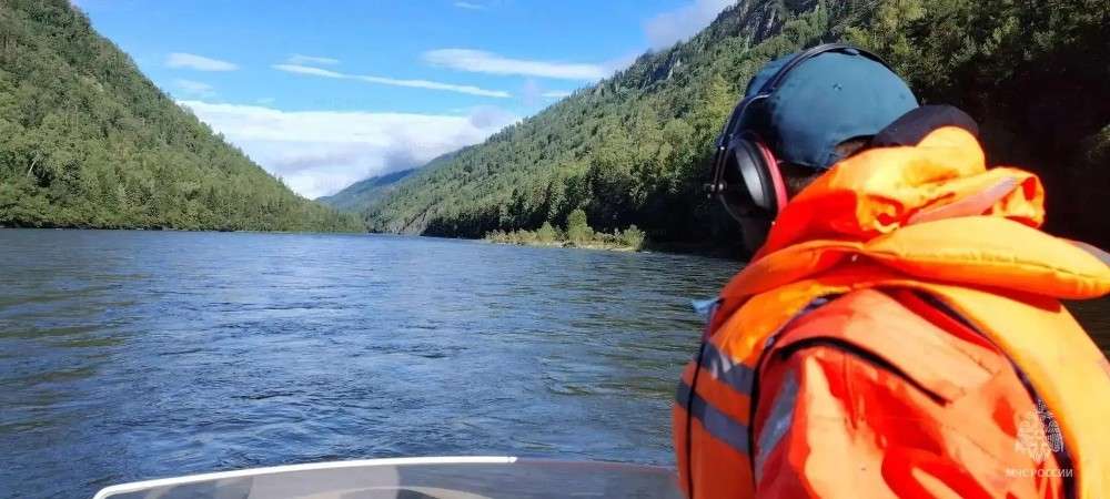 Человек в жилете на ка катере со спины