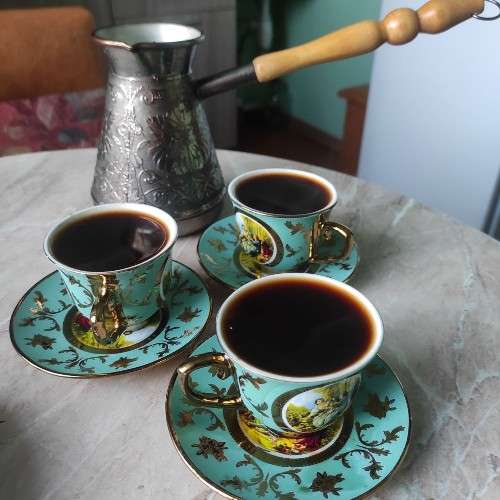 Три кружки с кофе и турка.