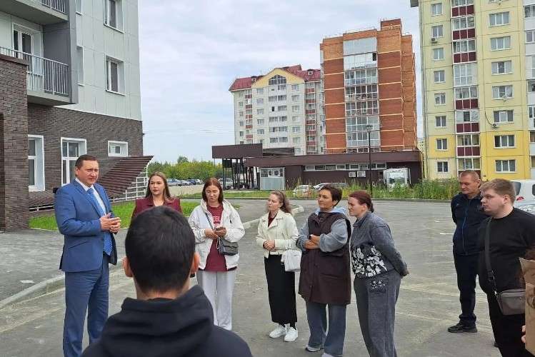 Люди возле многоквартирного дома